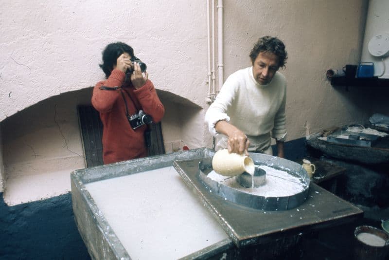 Gianfranco Gorgoni takes photographs of Robert Rauschenberg while he creates 'Page 2' from his 'Pages and Fuses' series, at Richard de Bas papermill, Ambert, France, 1973.