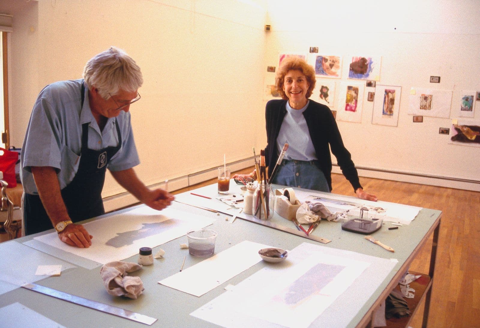 Colour photograph of Kenneth Tyler and Helen Frankenthaler working on 'This is not a book'