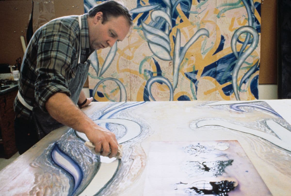 Colour photo of John Hutcheson inking woodblock for Steven Sorman’s ‘From away’