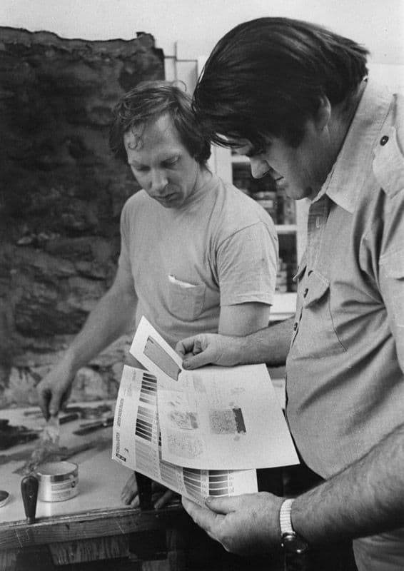 Black and white photograph of John Hutcheson and William Crutchfield studying colour samples for one of his colour lithographs