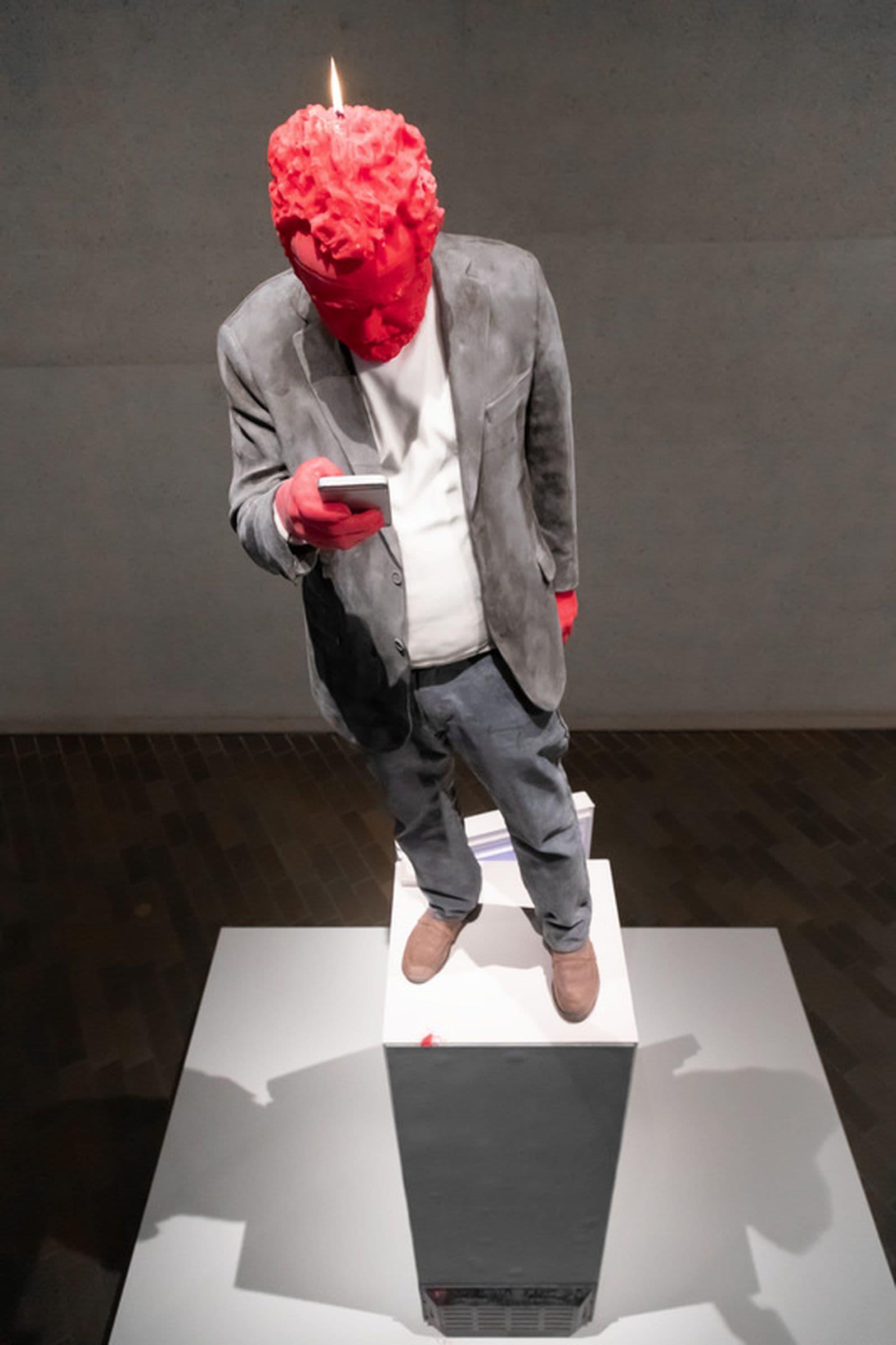 A red candle cast of a life sized figure