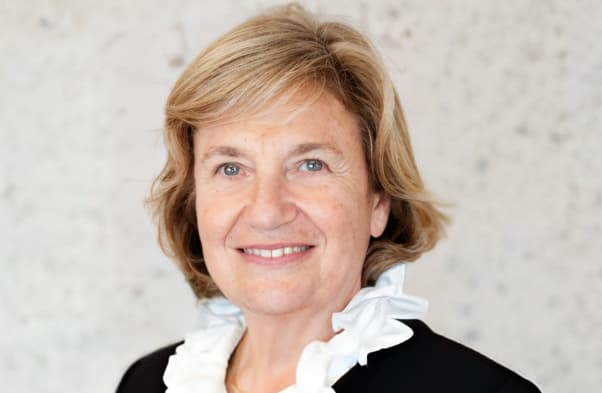 Photo of smiling woman in black suit with white shirt