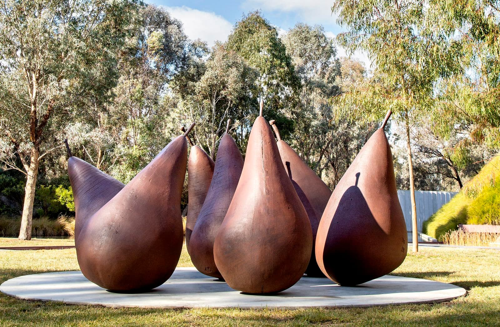 A group of seven brown metal pear sculptures