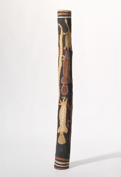 Traditional First Nations burial pole with red and yellow ochre snake, barramundi and tortoise imagery