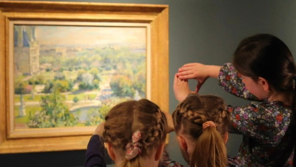 Video still of children looking at painting.