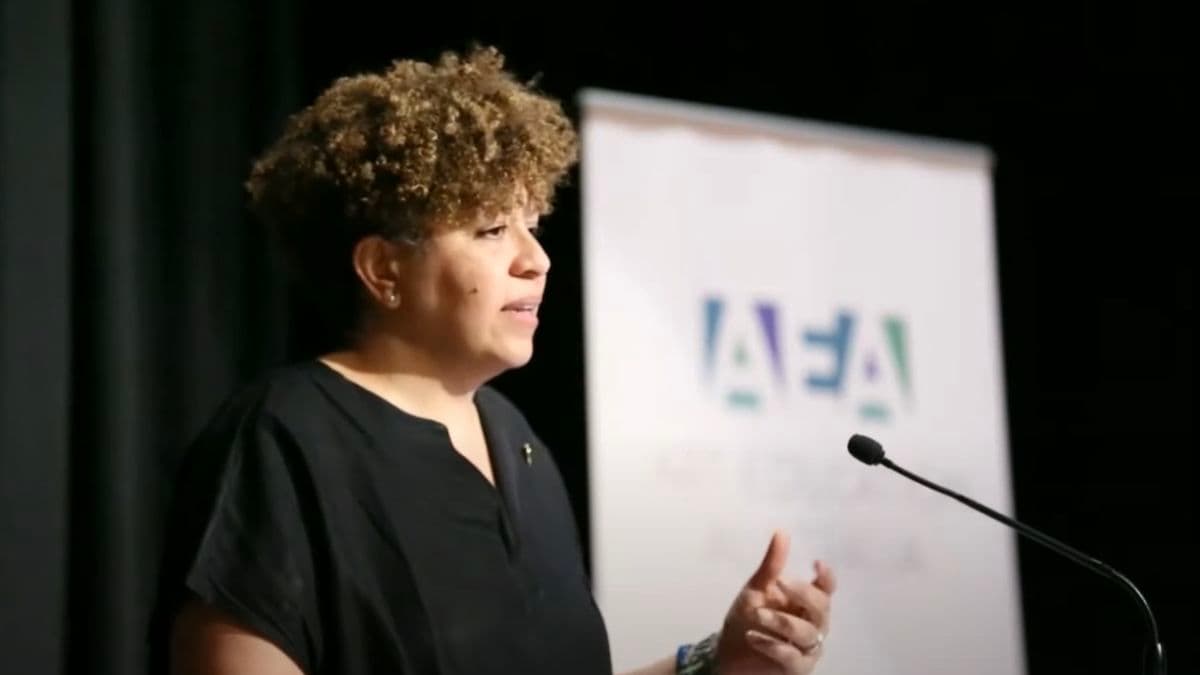 Video still of lady speaking during lecture.