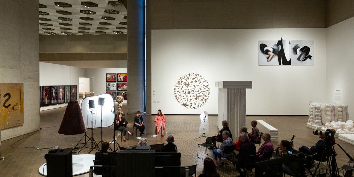Overview of the Gallery space with three women being interviewed.