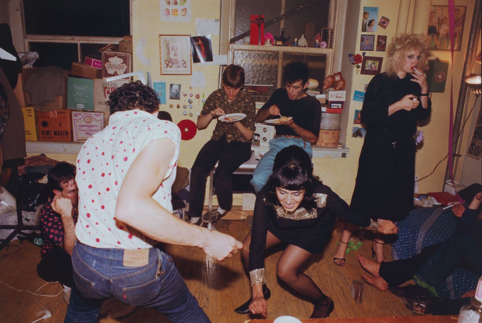 Friends of artist Nan Goldin dancing in an apartment at a birthday party.