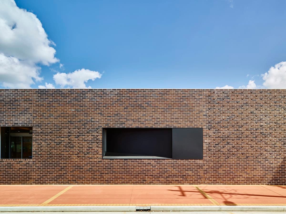 Photograph of brick building with blue sky