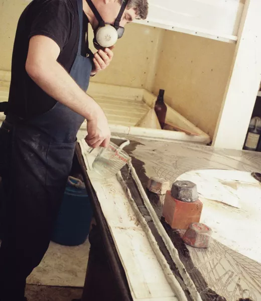 Colour photo of Anthony Kirk etching with acid one of the magnesium plates from ‘Moby Dick domes’ series,