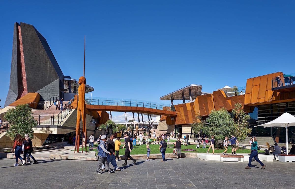 Photograph of exterior space with people and sculptural architecture