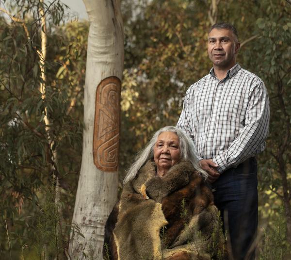 Image of Dr Matilda House and Paul Girrawah House in front of a scar tree