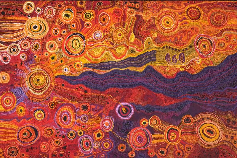 a large dot painting in bright colours
