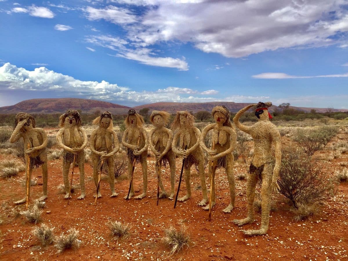 Eight woven figures in the desert
