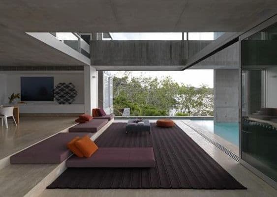 Photograph of domestic interior with lounges overlooking ocean
