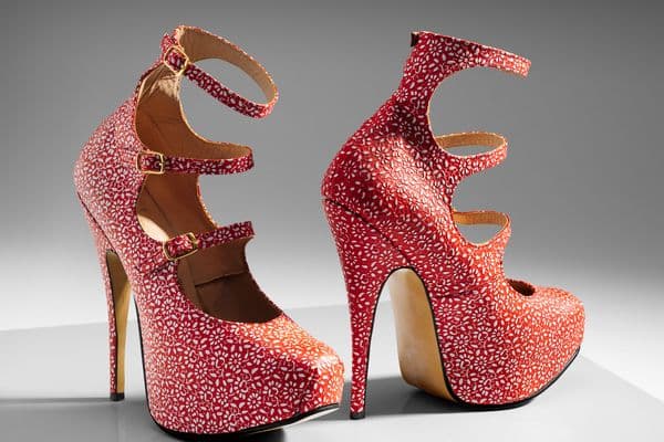 Pair of Red stiletto shoes with white flower detailing