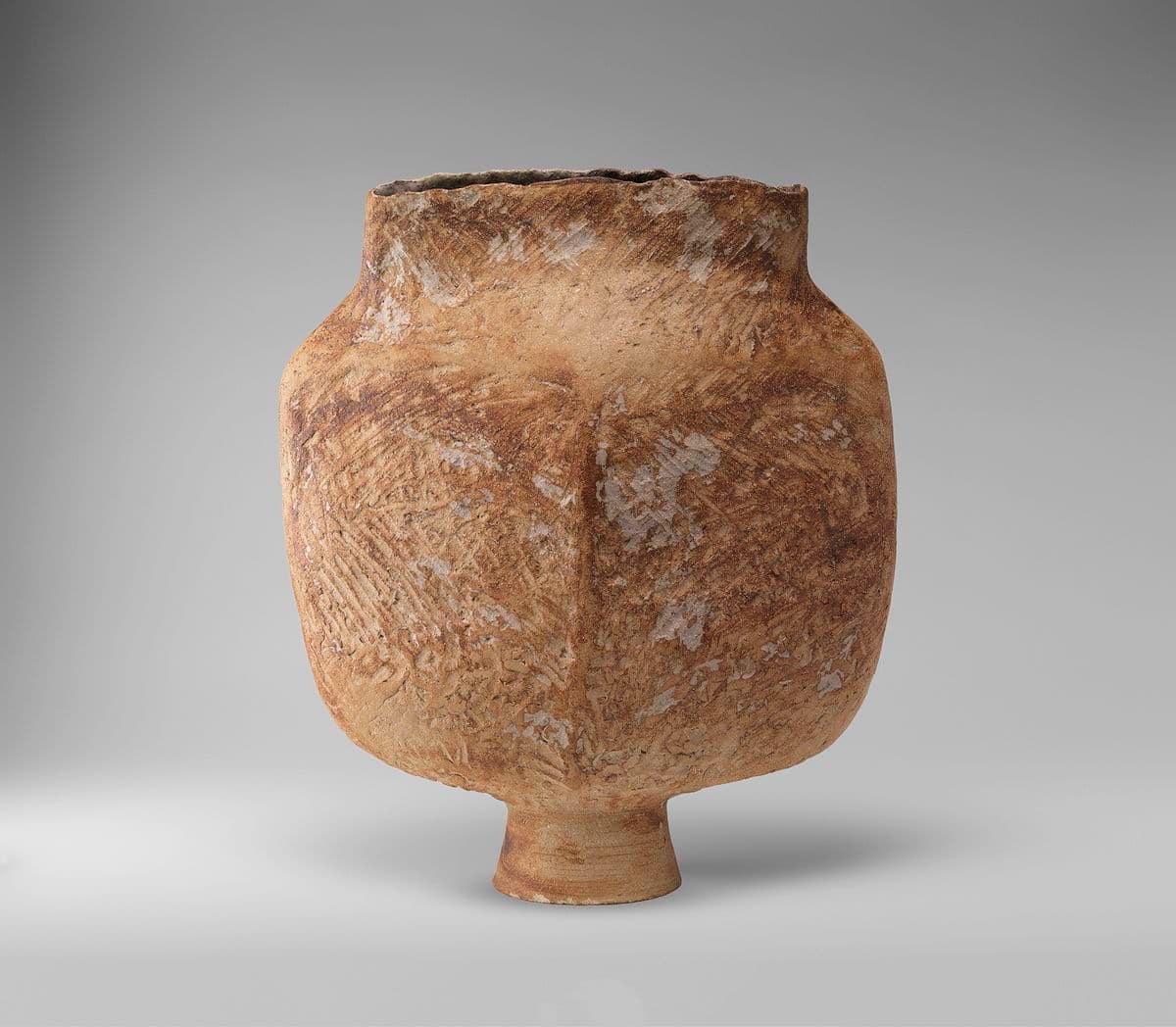 Hand built light brown ceramic vessel, textured finish.