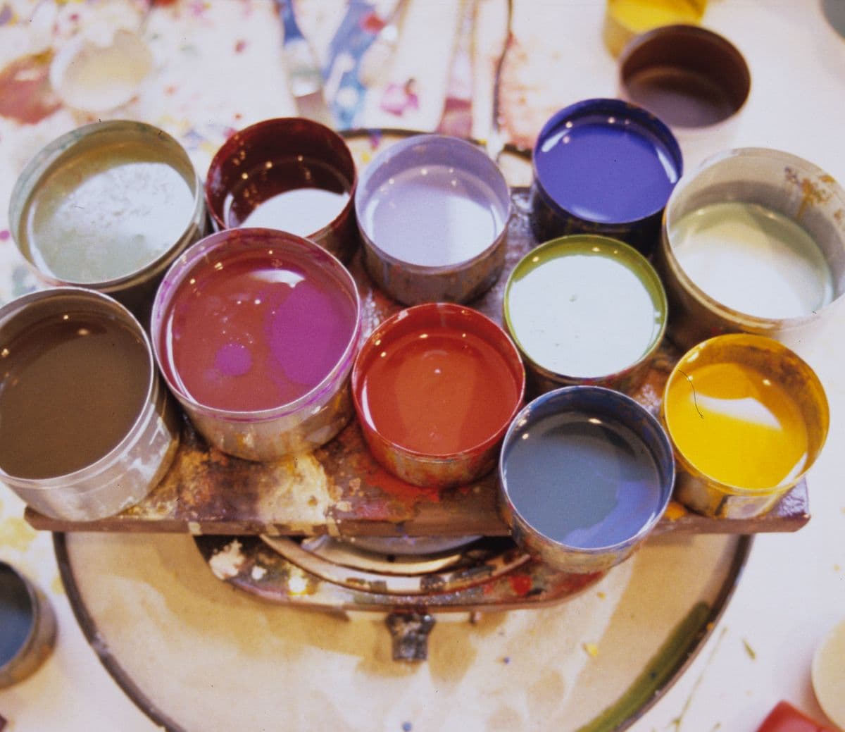 Varying sizes of tin pots filled with paint