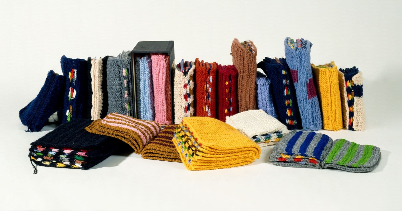 20 multicoloured knitted books in a line