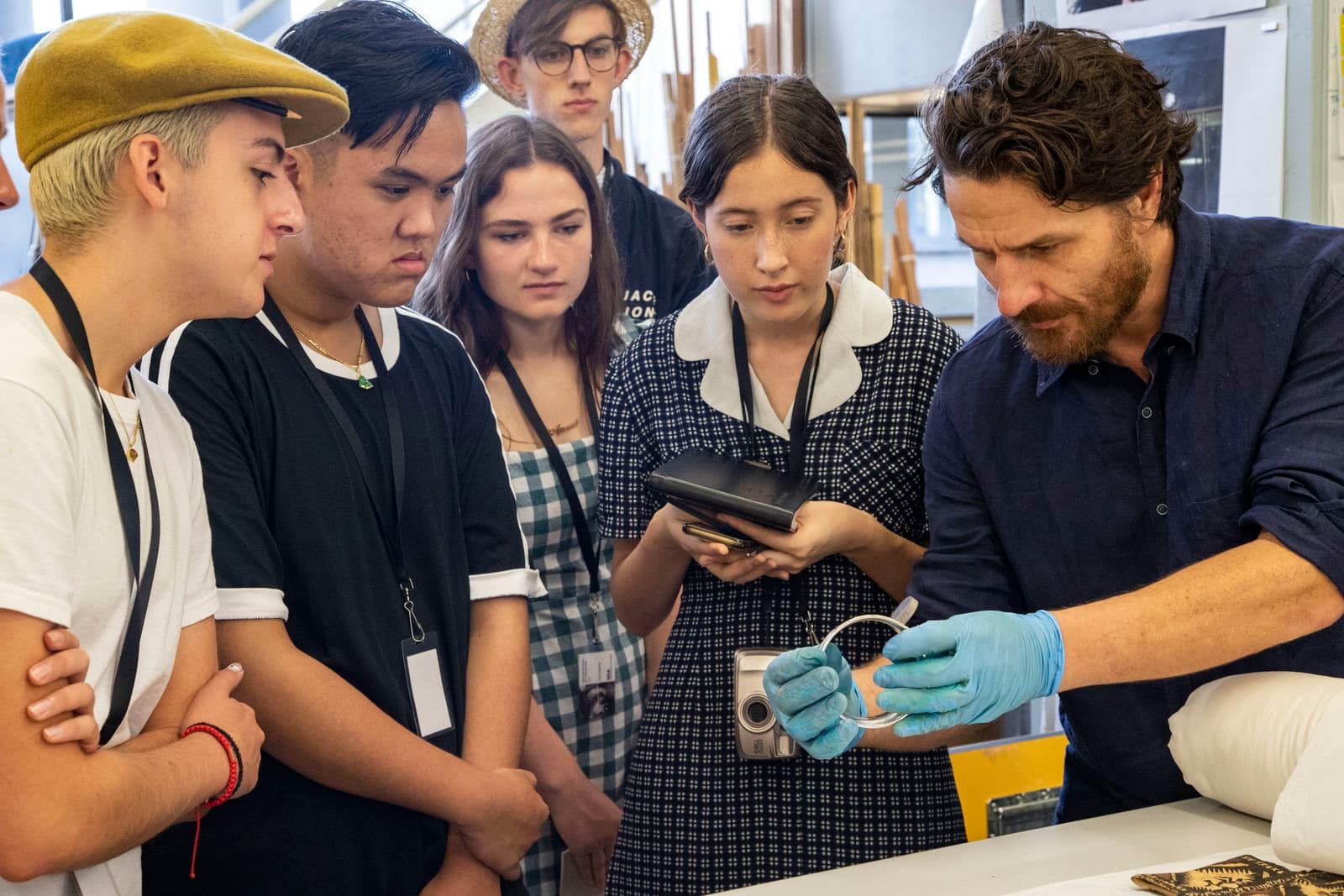 Photograph of young people looking at equipment behind the scenes