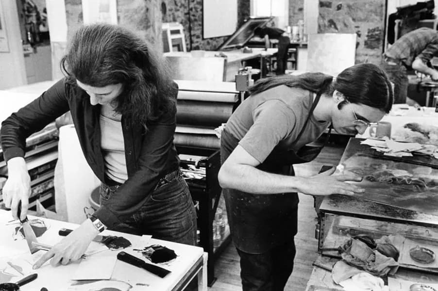 Nancy Graves mixes inks while Rodney Konopaki wipes copper intaglio plate in preparation for printing an impression