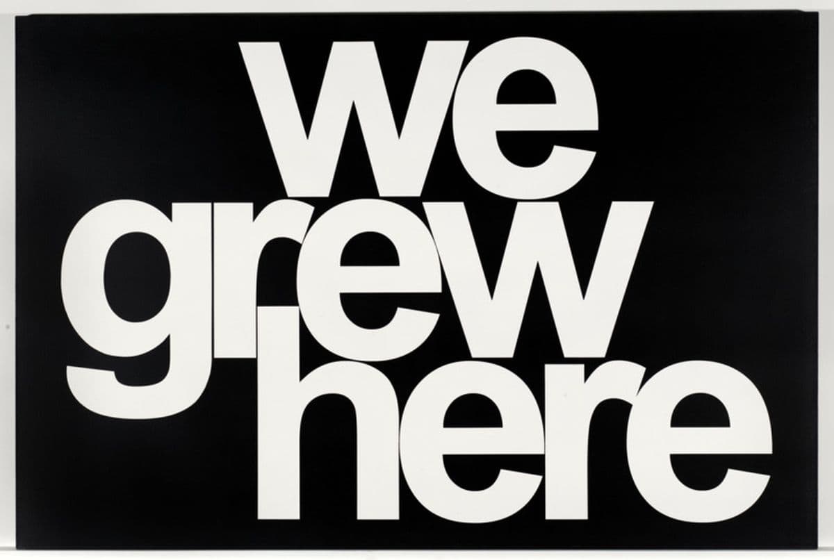 A black background with white text stating "we grew here"