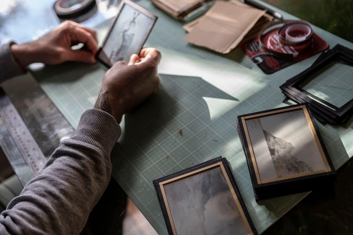 Photo graph of James Tylor sealing the silver plate of the daguerreotype behind glass