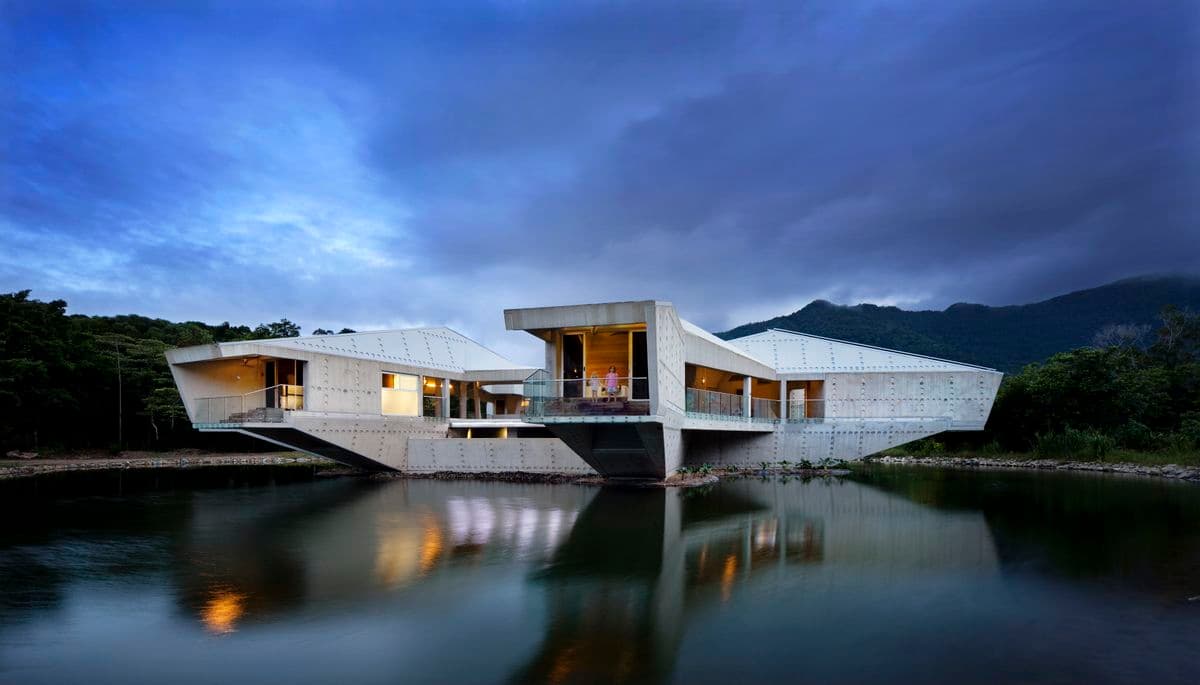 Photograph of white building on lake