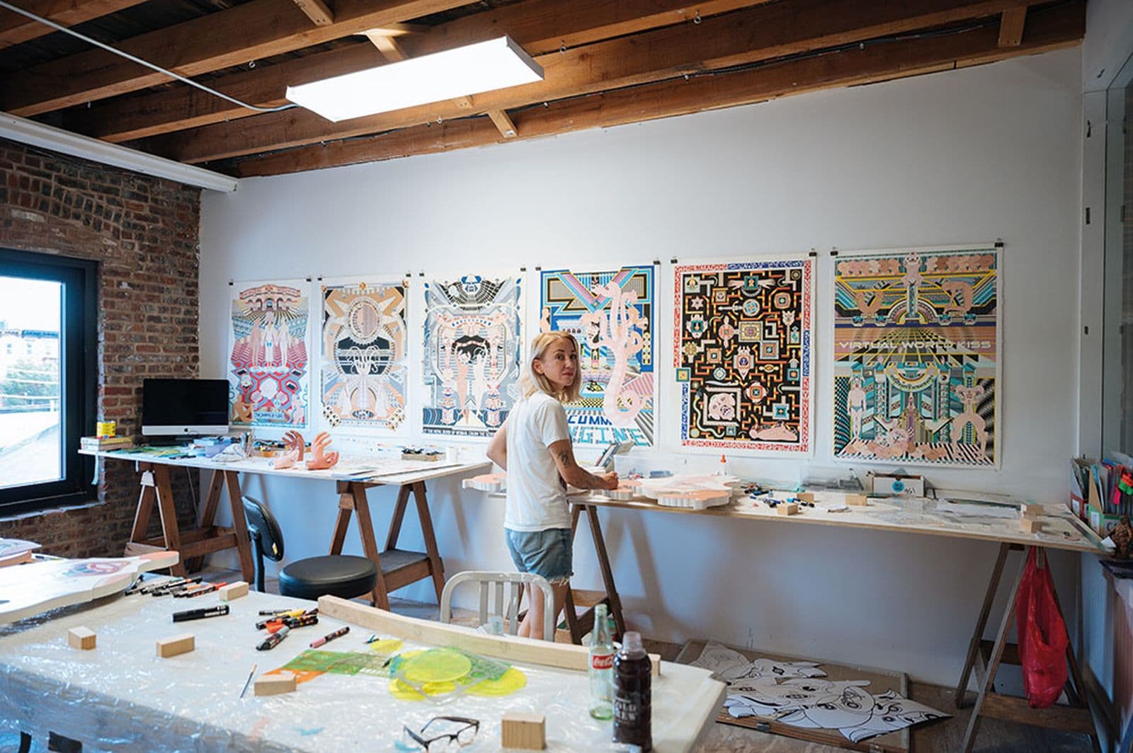 A woman stands in her art studio