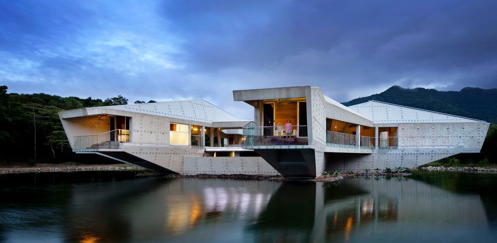 Photograph of white building on lake