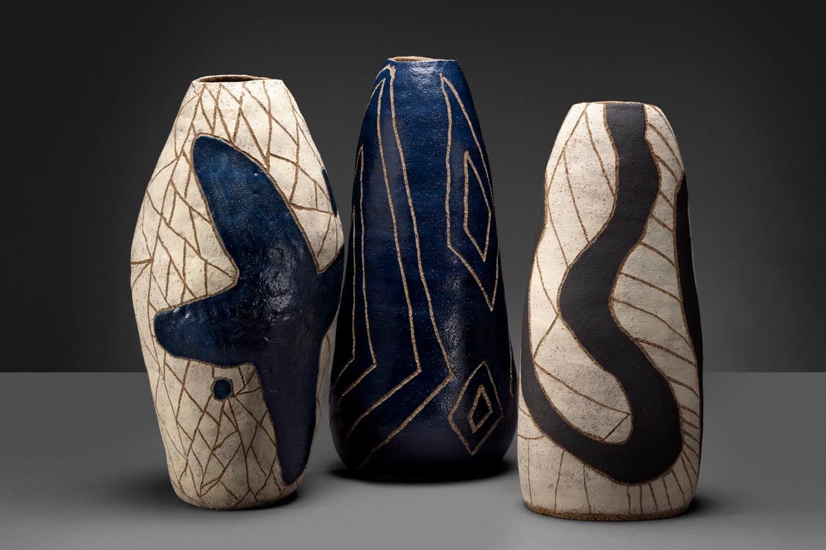 Photograph of three vases in a studio space