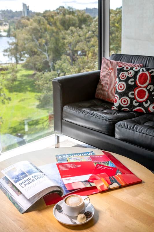 Photograph of Members Lounge with seating and collateral in view