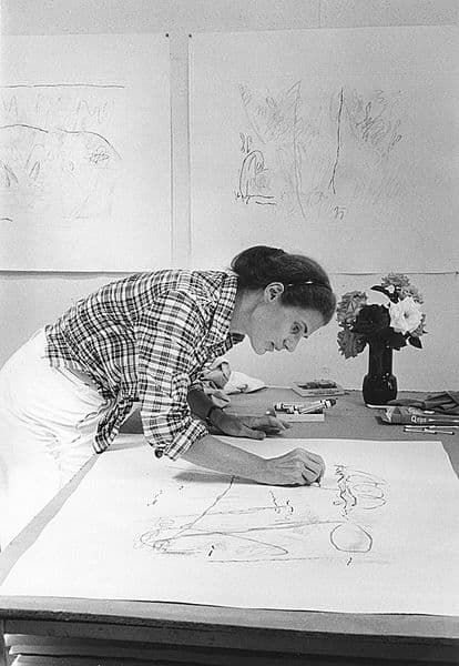 Black and white photograph of Nancy Graves drawing in her studio