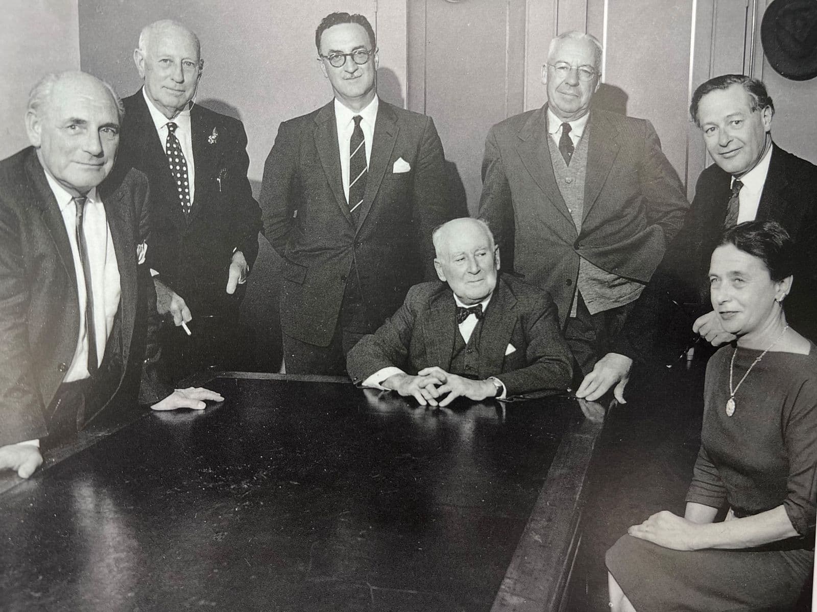 Black and white photograph of The Commonwealth Art Advisory Board c. 1958 Standing left to right: Robert Campbell, Sir Daryl Lindsay, Bill Cumming, Douglas Pratt, Sir William Dargie, Seated: Sir William Ashton (Chairman), Valda Leehy (Secretary) Photo: courtesy Jean Campbell, Canberra