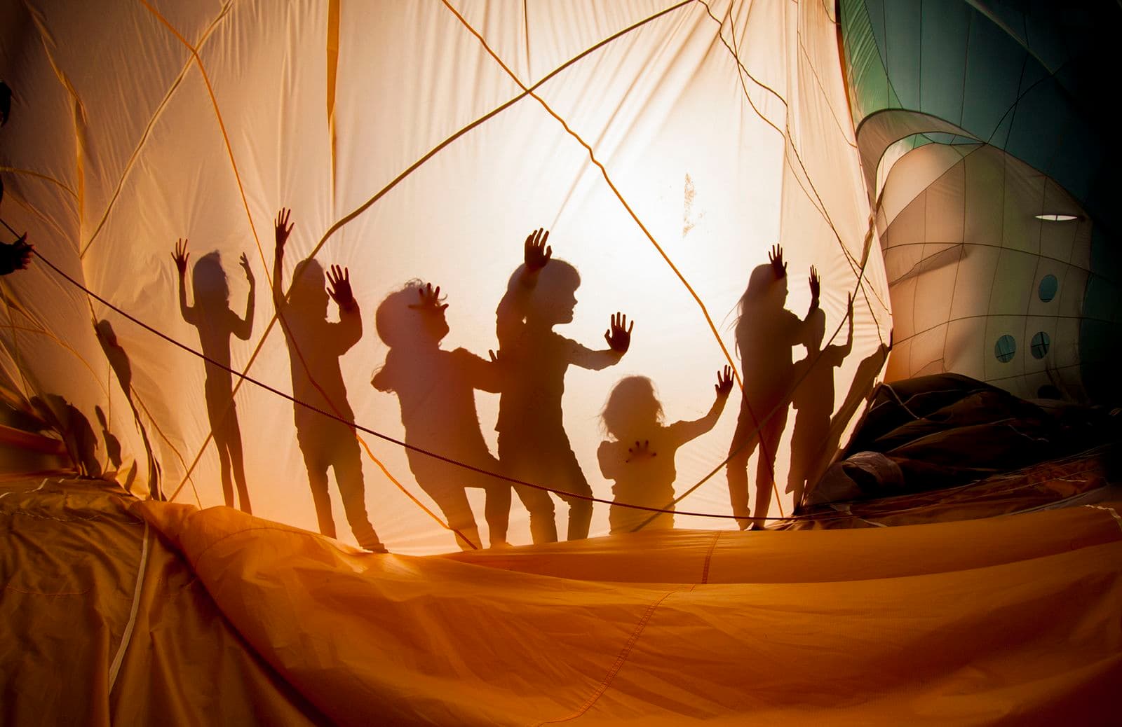 Photograph of balloon with silhouettes of kids playing