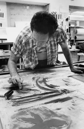 Ed Baynard using his finger to ink a passage on the third woodblock during the trial proofing of his ‘The Dragonfly Vase’ print on the lithography offset press bed