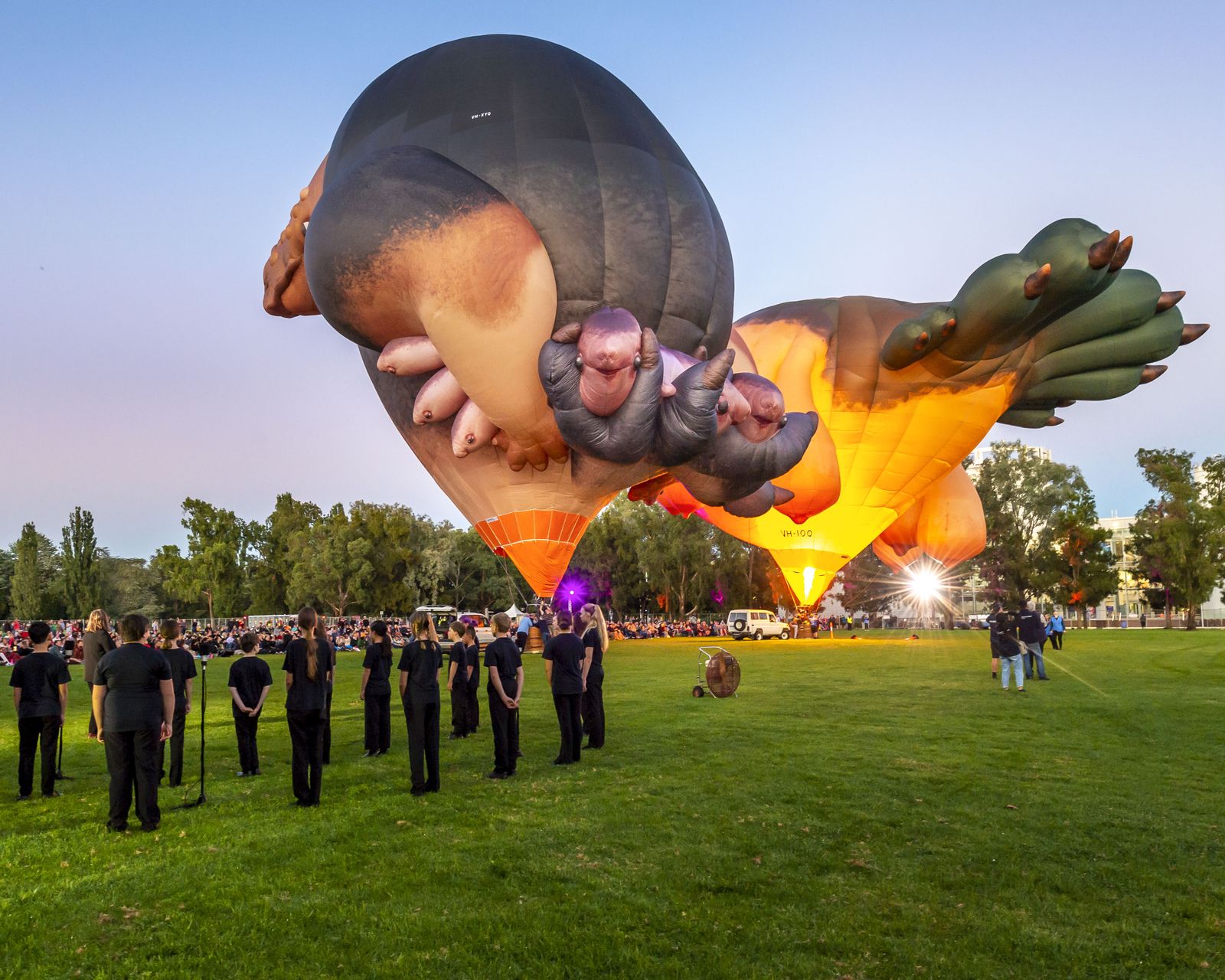 Image of Skywhale 2013 and Skywhalepapa 2020 at Canberra launch in 2021 with Luminescence Children's Choir