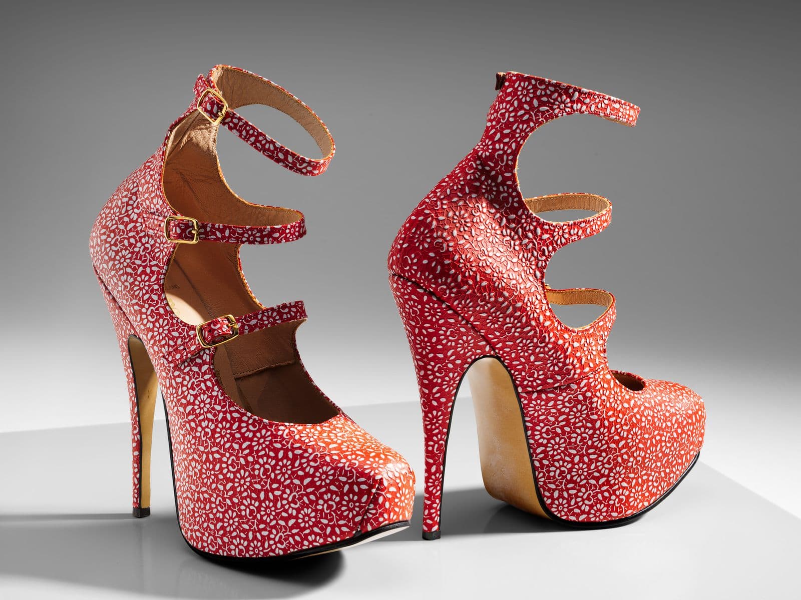 Pair of Red stiletto shoes with white flower detailing