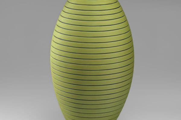 A large green quenelle shaped glass sculpture with horizontal grooves
