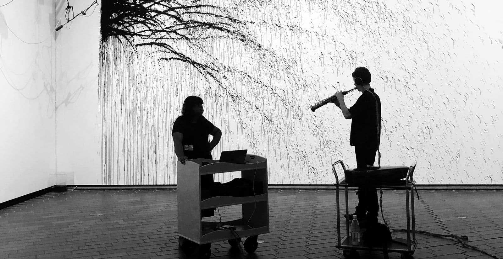 Sound artist Sia Ahmad and musician Tom Fell capturing the sound of the a saxaphone being played at the National Gallery