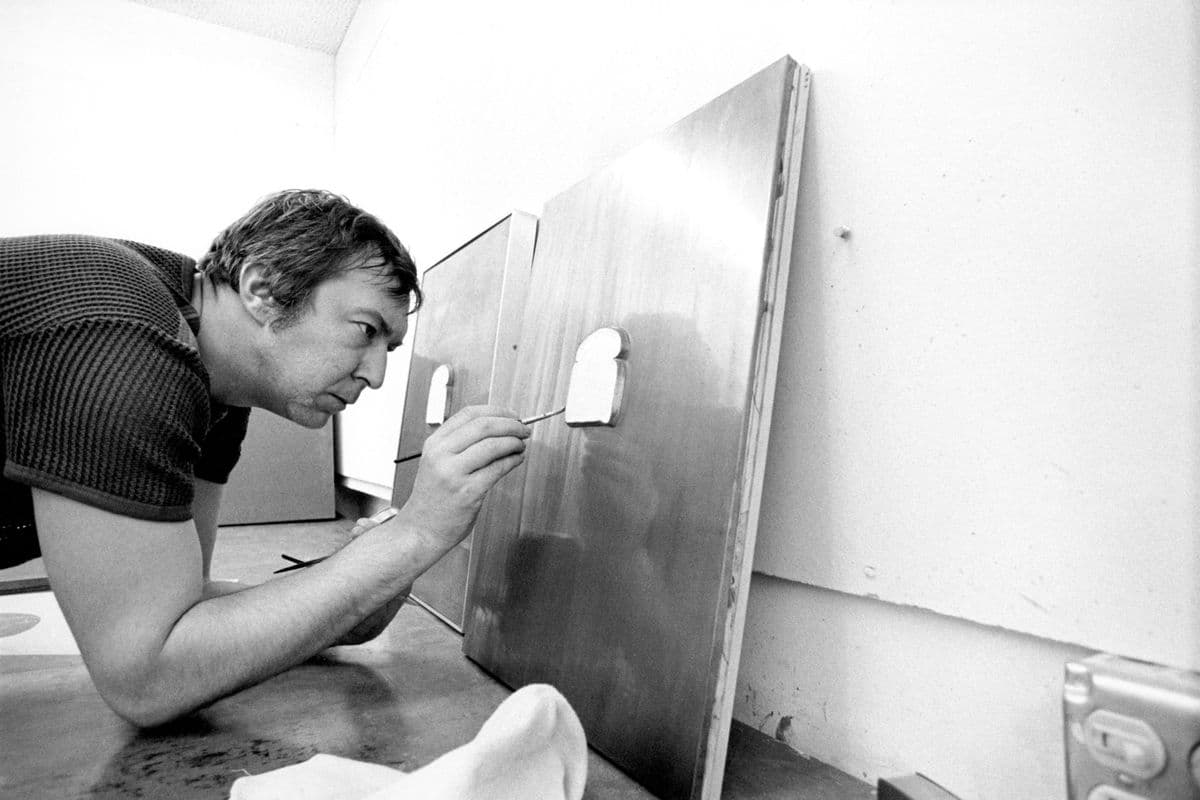 Jasper Johns painting the lead relief 'Bread' with oil paint, Gemini G.E.L., Los Angeles, 1969.
