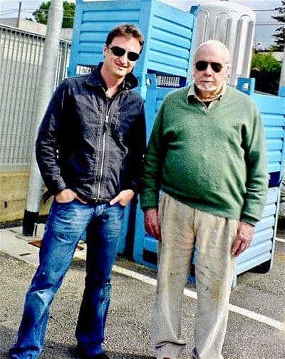 Two men wearing sunglasses standing next to each other