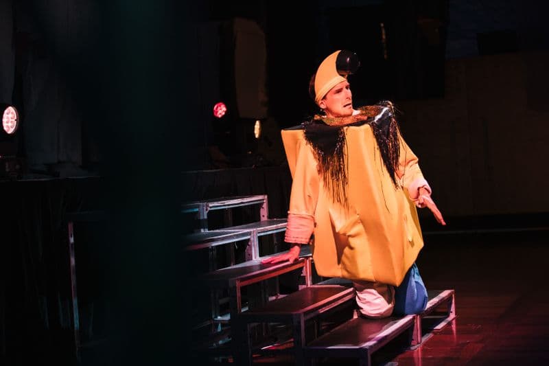 Photo of male performer in yellow square costume