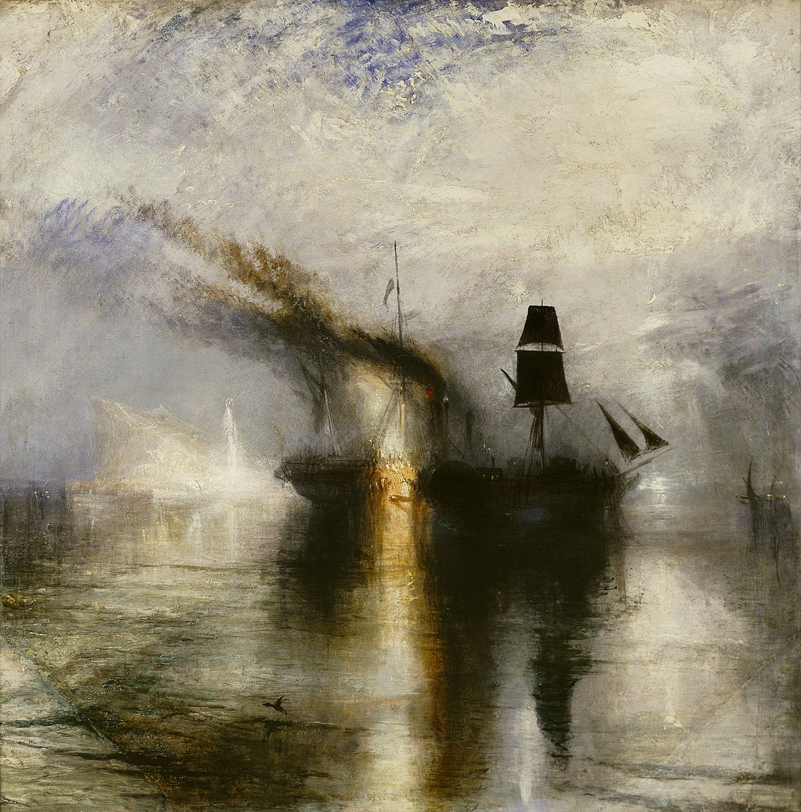 A ship burns in a harbour, surrounded by other ships