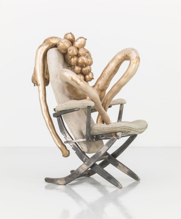 bronze, concrete and cast iron sculpture depicting abstract figure sitting on chair