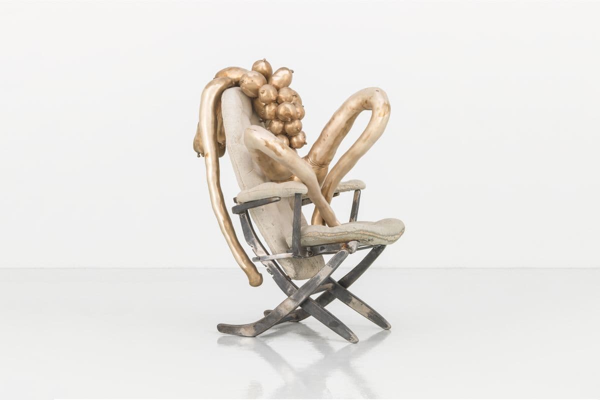 Bronze sculpture of seated, abstracted female body