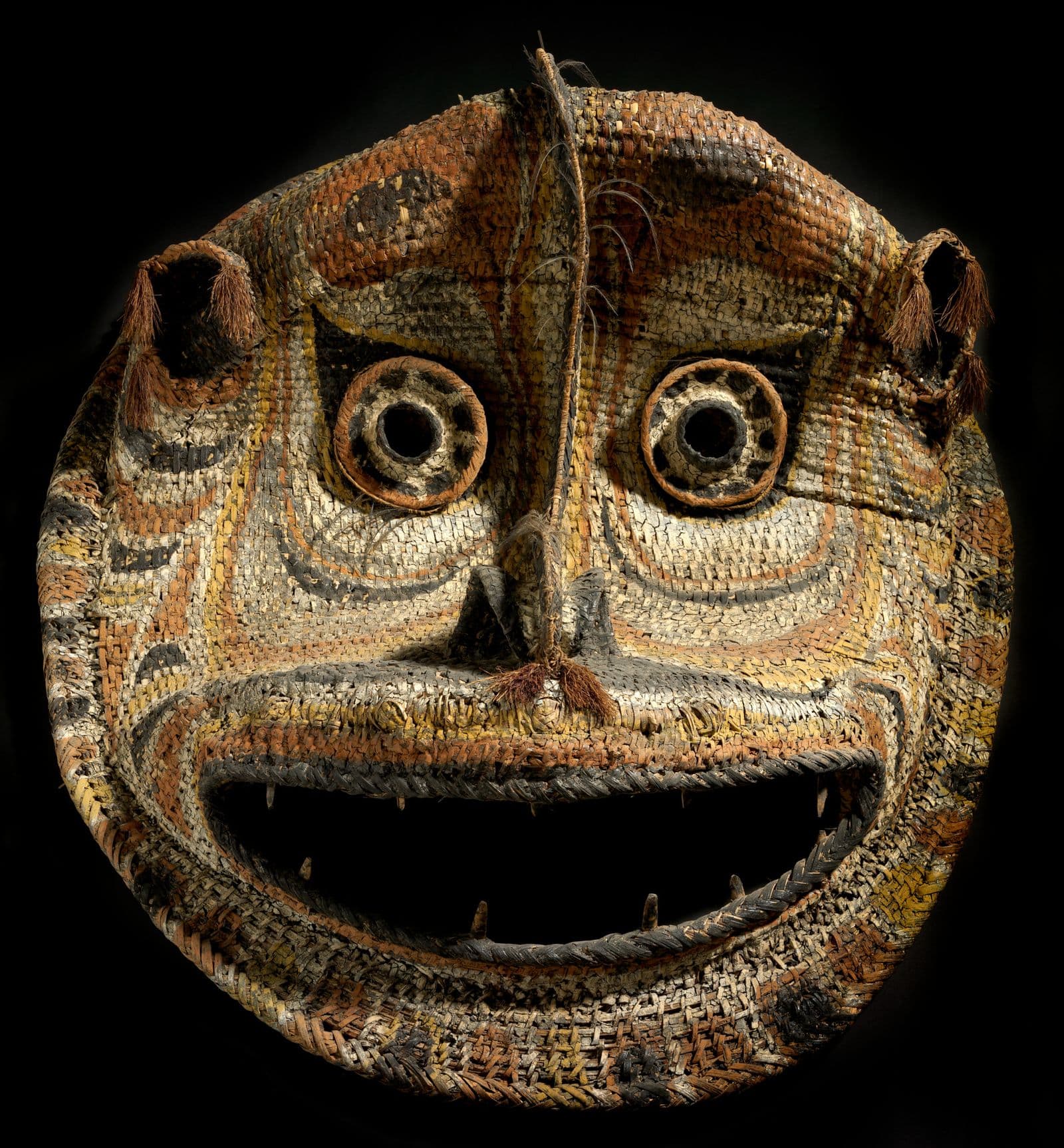 Traditional Cane mask with wide eyes and mouth, red, blak and  cream coloured cane