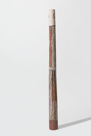 Tall pole with ochre and yellow pythons, and a repeating diagonal striped pattern