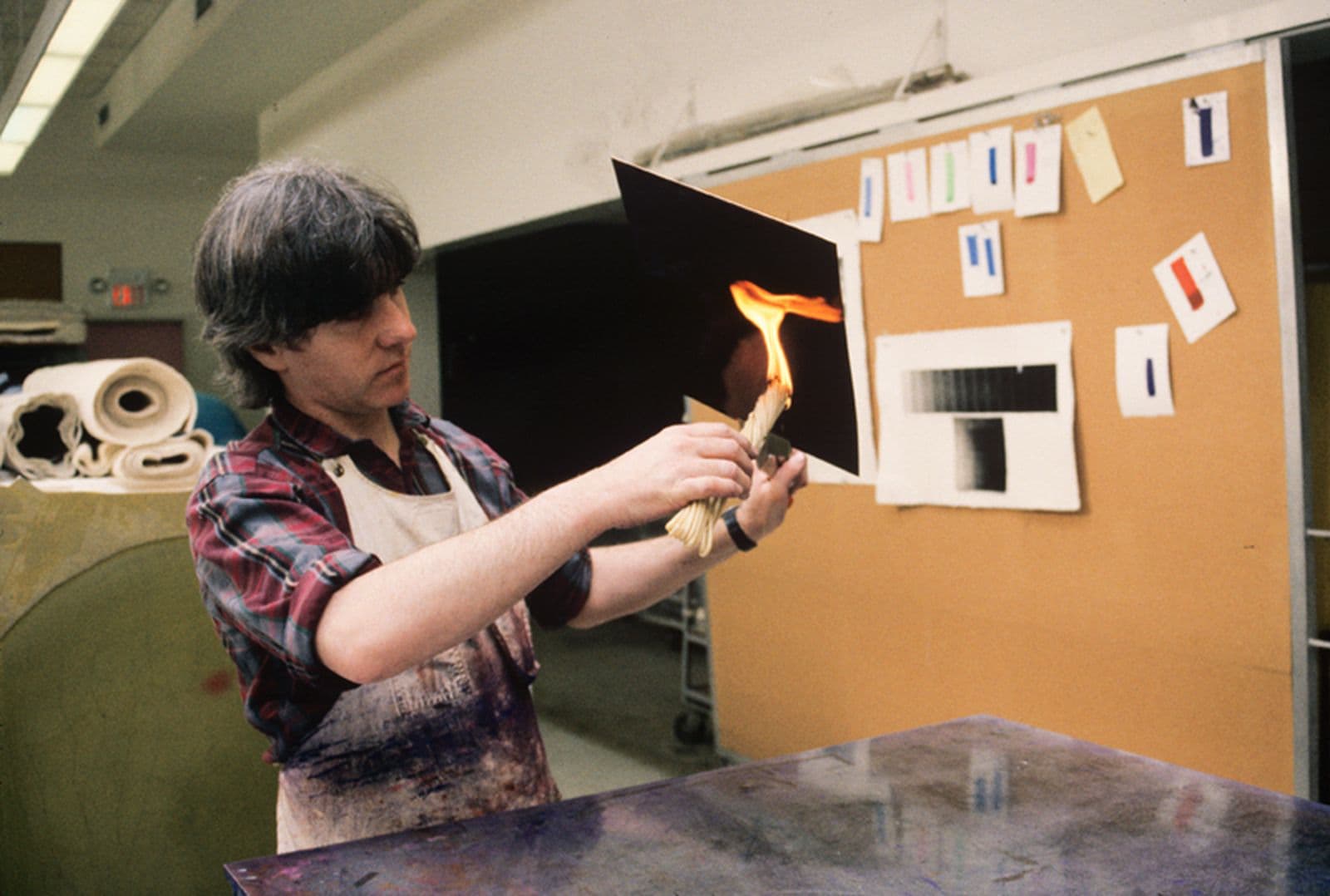 Colour photograph of Anthony Kirk heating intaglio plate to soften etching ground