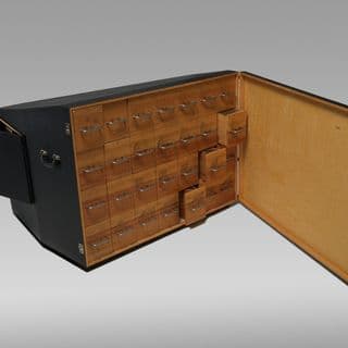 A wooden case with multiple drawers.